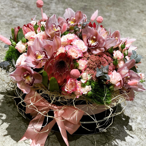 Pink Cymbidium orchid, roses and exotic flowers.